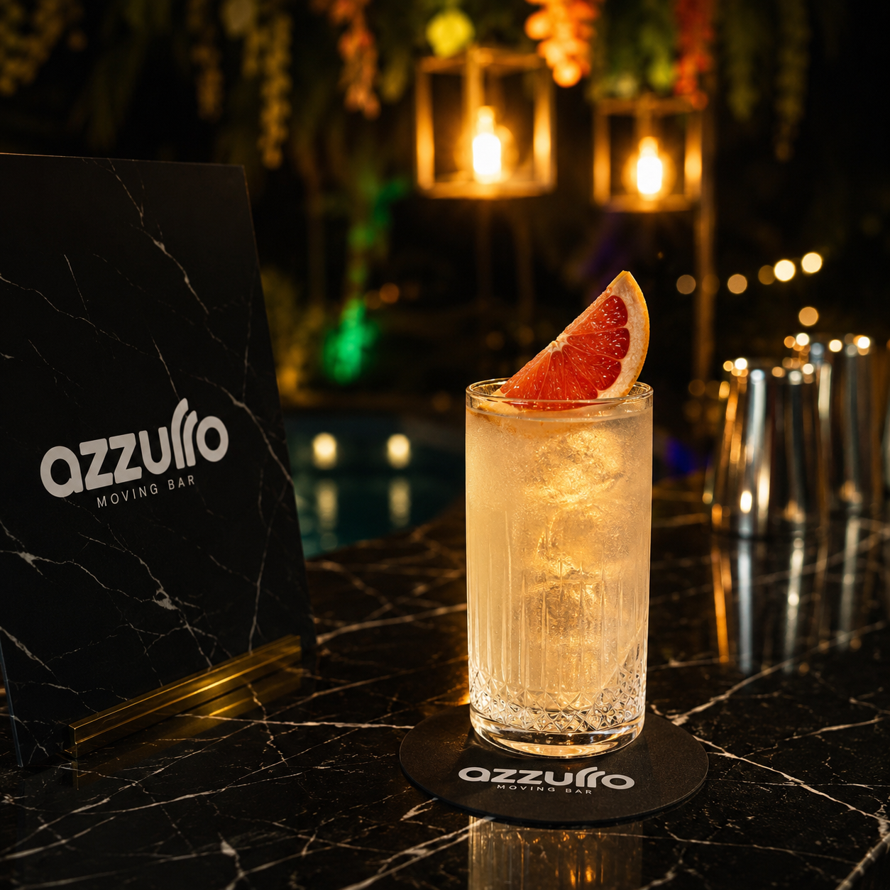 Azzurro Moving Bar signature cocktail with grapefruit garnish on a black marble bar in Cyprus, warm lantern lighting