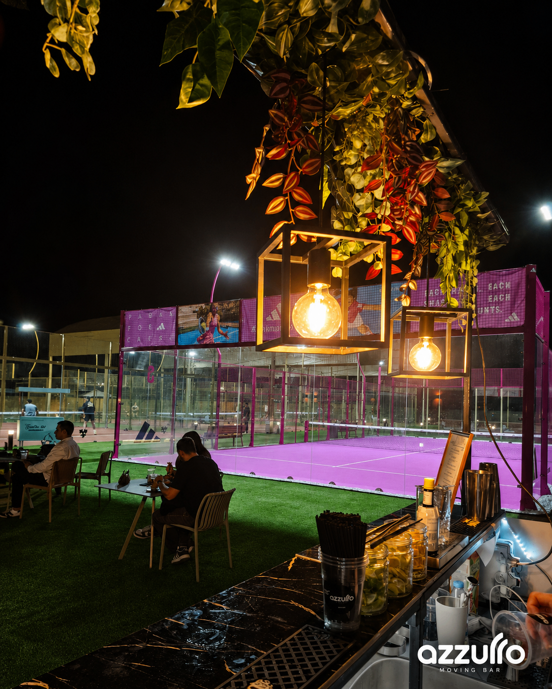 Azzurro Moving Bar setup beside illuminated padel courts at night in Cyprus